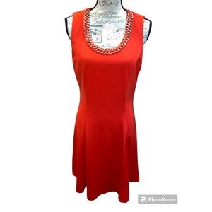 Women’s vibrant orange sleeves dress, beaded gold chain around neck line Party